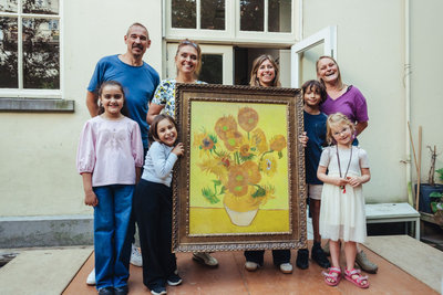 Kinderen en begeleiders van de basisschool Oscar Carré ontvangen een Van Gogh Zonnebloemen replica