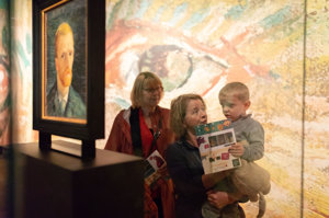 A toddler is looking at a Self-Portrait of Vincent van Gogh, together with his grandmother. Photo: Brenda Roos