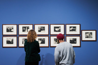 Two visitors look at 11 of Félix Vallotton’s woodcuts in the exhibition 'Here to Stay'. Photo: Tomek Dersu Aaron