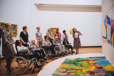 Participants of the Hyundai x Van Gogh Museum Connection Day are looking at Etel Adnan's artworks during the guided tour of the exhibition Colour as Language. Photograph: Jelle Draper
