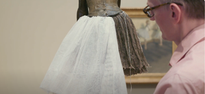 Costume conservator  Glenn Peterson tries on a new fabric for the tutu of Degas' sculpture of a ballerina at the Metropolitan Museum of Art in New York