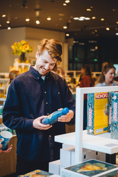 A visitor admires a Van Gogh water bottle in the flagshipstore. Photo: Jelle Draper