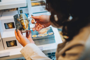 A visitor holds a Van Gogh mug in the Van Gogh Museum shop. Photo: Jelle Draper