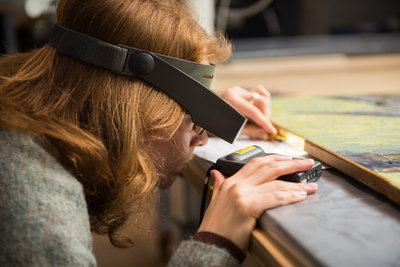 A conservator examines a Van Gogh painting. Photo: Maartje Strijbis