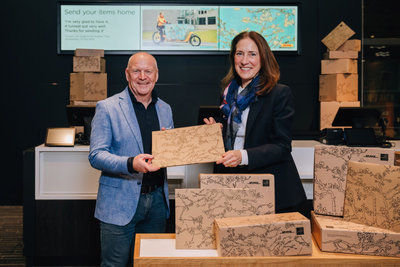 Emilie Gordenker, Director of the Van Gogh Museum, and Kees de Lange, Managing Director of DHL Express, seal the partnership in the Museum Shop. Photograph: David Stegenga
