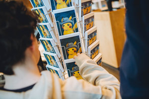 A young visitor browses Pokémon postcards in the flagshipstore of the Van Gogh Museum. Photo: Jelle Draper