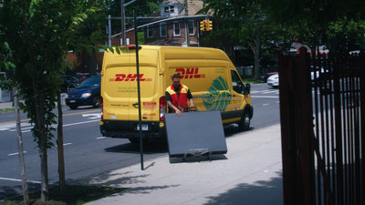 DHL courier delivering a Van Gogh Museum Edition at a school in New York City in support of the Heart for Art programme. Credit: Mals Media