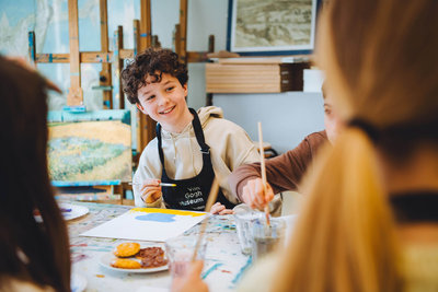 A child participates in a painting workshop. Photo: Jelle Draper